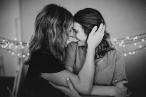 two girl cuddling, b&w photo