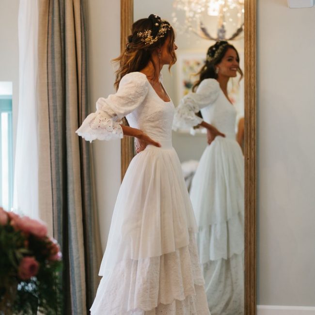 the bride looks in the mirror