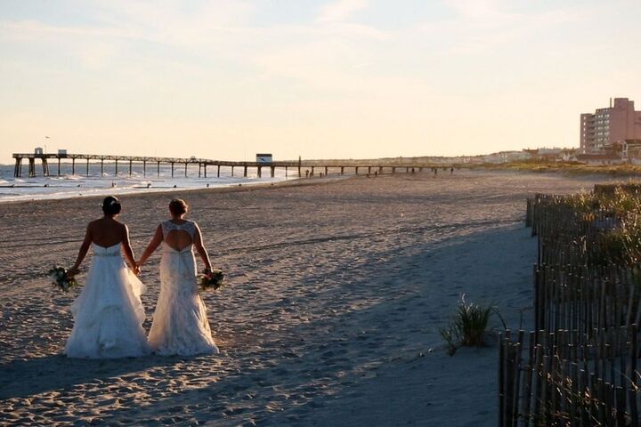 two brides on the beach