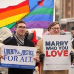 Two men staying with posters about Marriage Rights for LGBTQ couples
