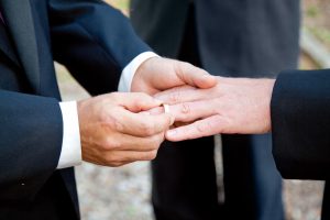 Two men exchange rings at wedding