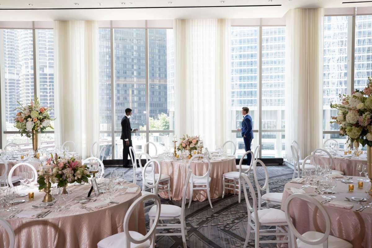 Two men close to window before their wedding ceremony