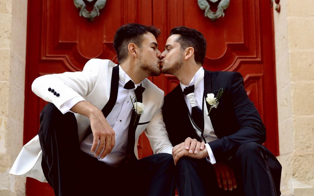 Two grooms kissing