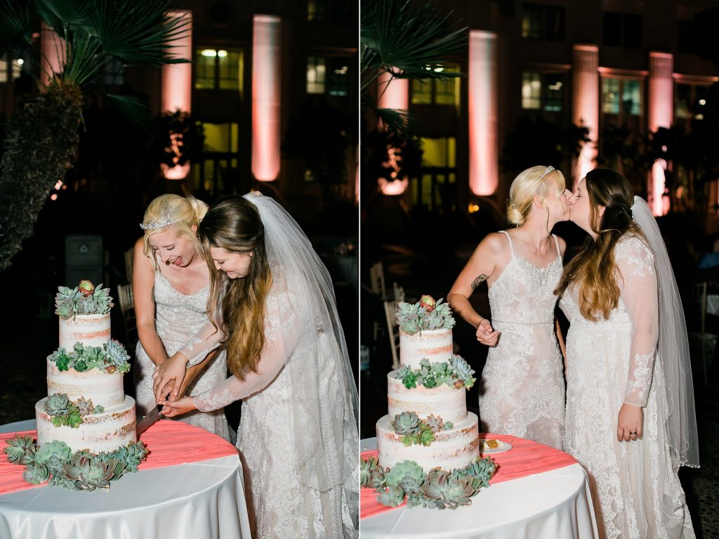 Two brides are cutting wedding cake and kissing